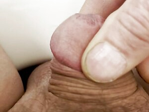 Playing with tiny cock on toilet
